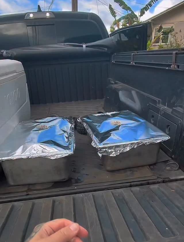 Foil catering pans loaded in a truck bed, ready to feed a crowd